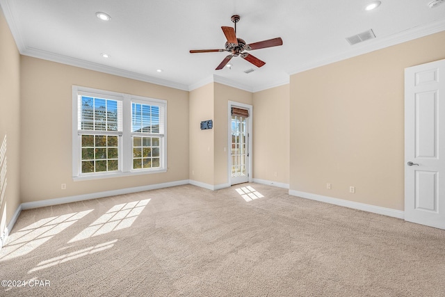 spare room featuring light carpet, ornamental molding, and ceiling fan