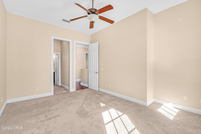 unfurnished bedroom with light colored carpet and ceiling fan