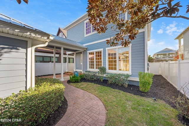 property entrance with a lawn