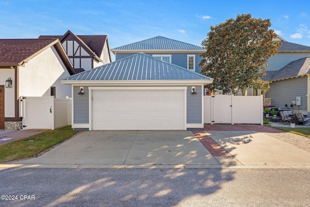 view of front of house featuring a garage and an outdoor structure