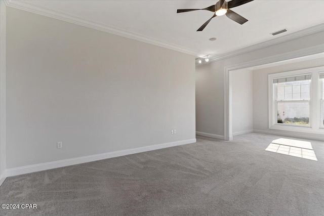 carpeted spare room with ceiling fan and crown molding