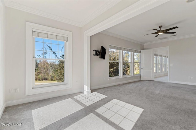 unfurnished living room featuring light colored carpet, ceiling fan, and ornamental molding