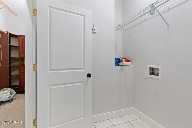 laundry room featuring light tile patterned floors and hookup for a washing machine