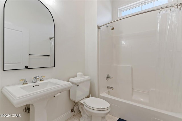 full bathroom featuring sink, shower / tub combo with curtain, tile patterned flooring, and toilet