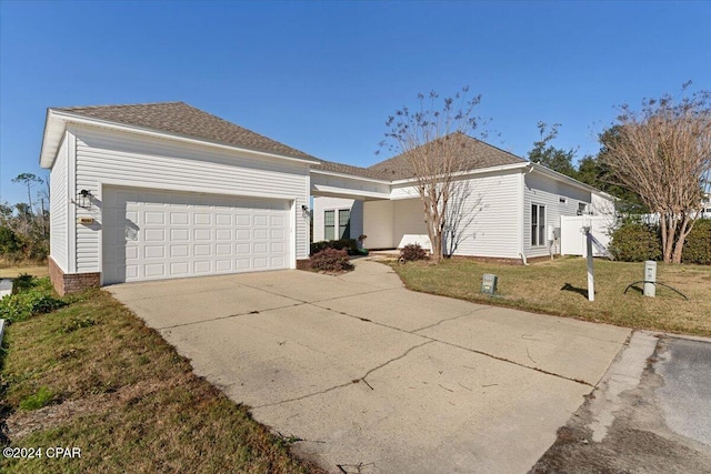 view of front facade featuring a garage and a front lawn