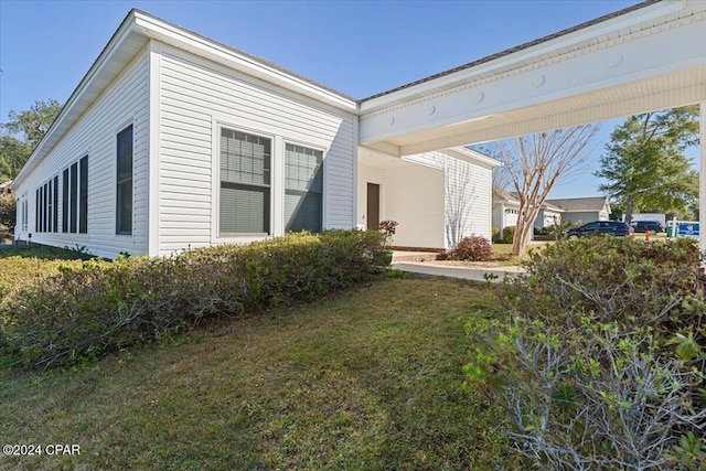 view of property exterior with a lawn