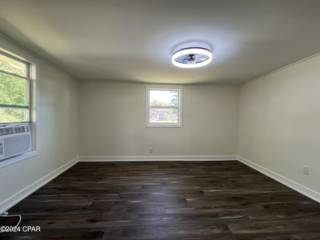 unfurnished room with dark hardwood / wood-style flooring