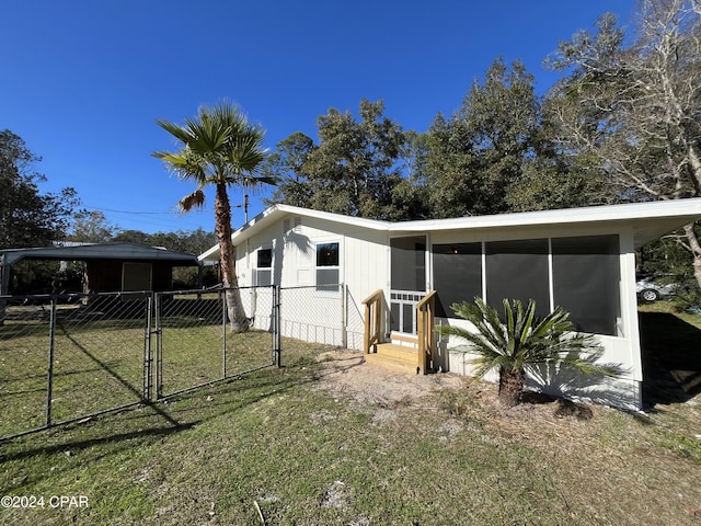 view of front facade featuring a front yard and a sunroom