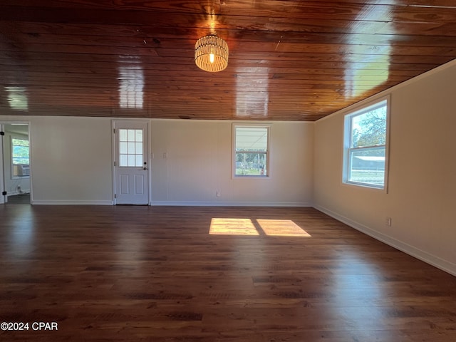 unfurnished room with cooling unit, dark hardwood / wood-style floors, and wooden ceiling