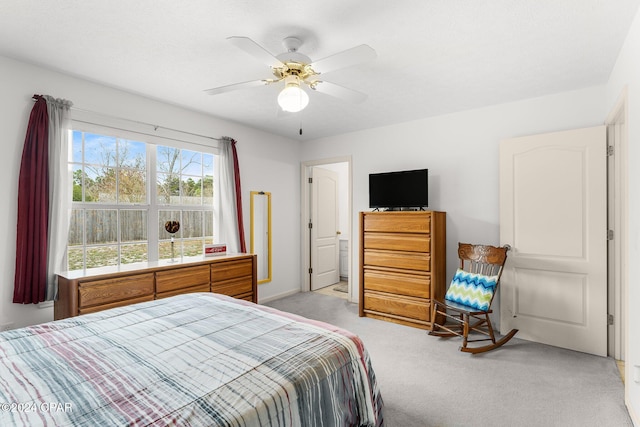 bedroom featuring light carpet and ceiling fan