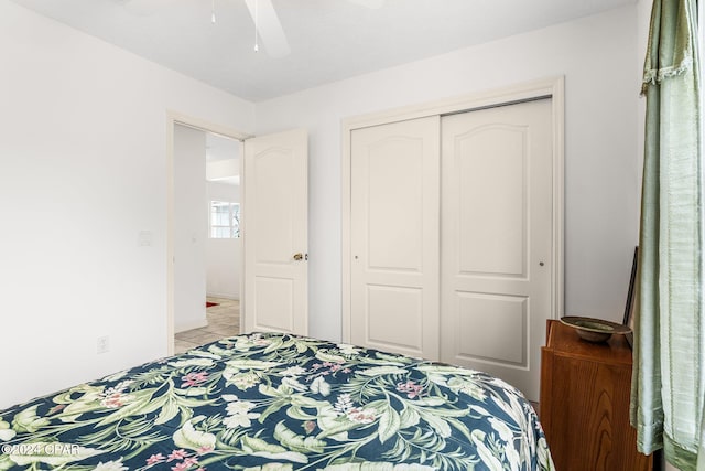 bedroom with ceiling fan, a closet, and light tile patterned flooring