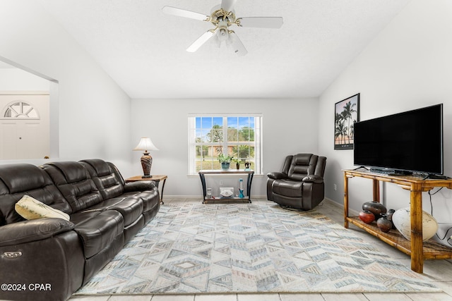 living room with vaulted ceiling, ceiling fan, and a textured ceiling