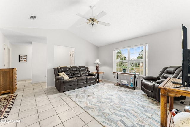 living room featuring ceiling fan, light tile patterned floors, and lofted ceiling