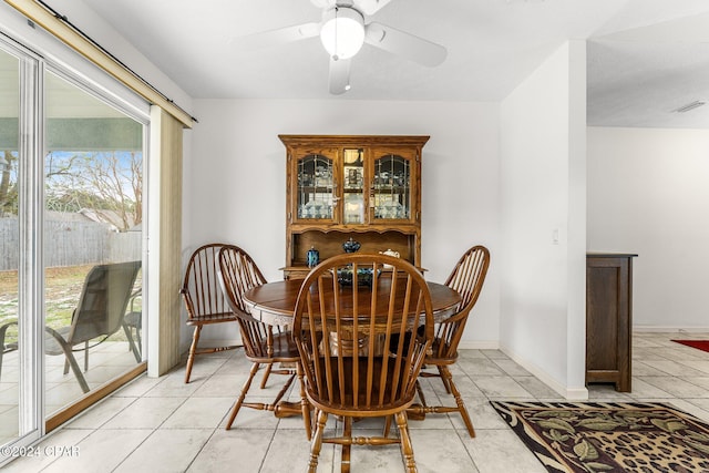 tiled dining space with ceiling fan