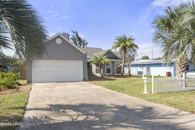 ranch-style home featuring a garage and a front yard