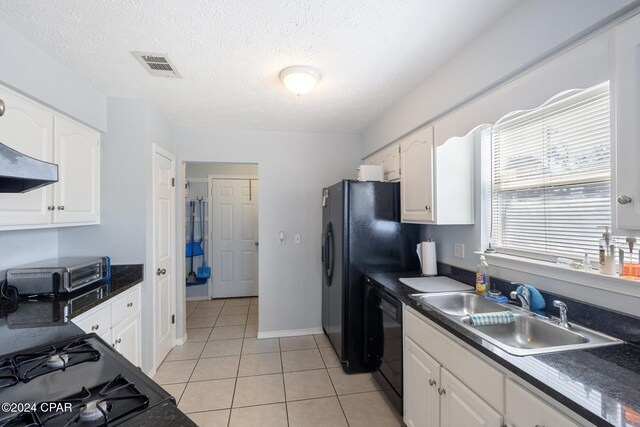 kitchen featuring black appliances, sink, light tile patterned floors, a textured ceiling, and white cabinetry