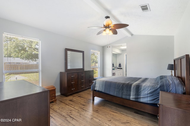 bedroom featuring multiple windows, connected bathroom, light hardwood / wood-style floors, and ceiling fan