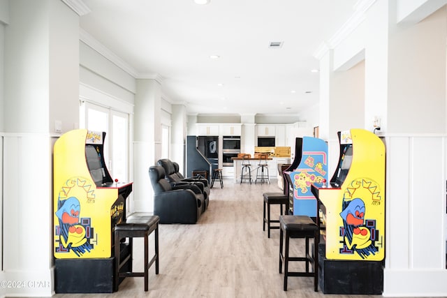 living room with light hardwood / wood-style flooring and ornamental molding