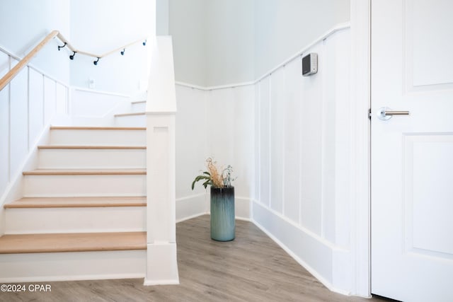 stairs featuring wood-type flooring