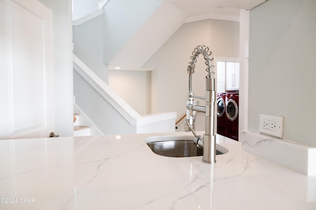 interior details with washer and dryer and light stone countertops