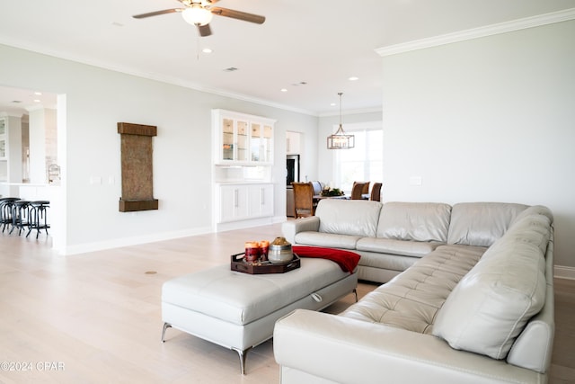 living room featuring ceiling fan, light hardwood / wood-style floors, and ornamental molding