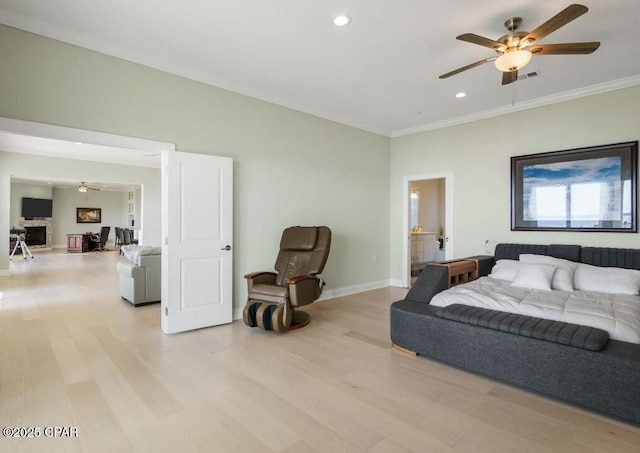 bedroom featuring ceiling fan, light wood-type flooring, and ornamental molding