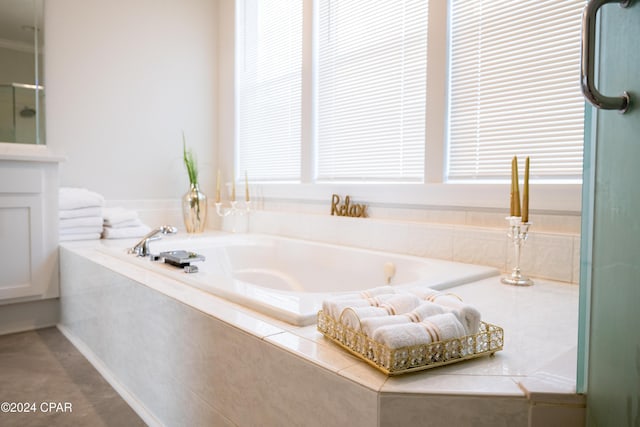 bathroom with a relaxing tiled tub