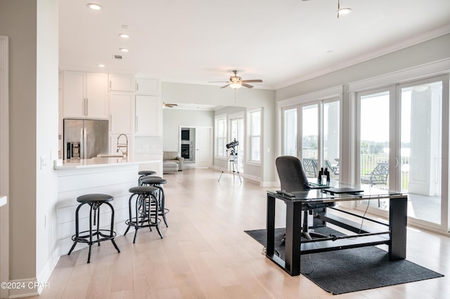 interior space with ceiling fan, french doors, sink, and light hardwood / wood-style floors