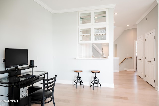 office space featuring ornamental molding and light hardwood / wood-style floors