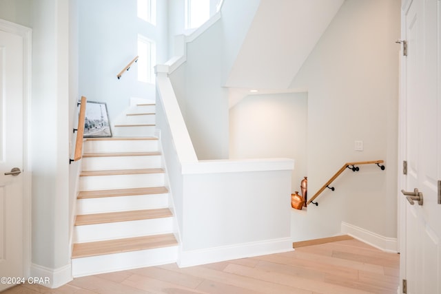 stairway with hardwood / wood-style flooring