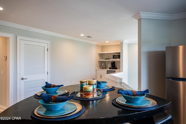 kitchen featuring stainless steel appliances, crown molding, and white cabinets