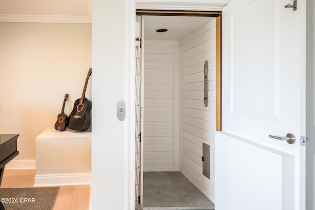 bathroom featuring ornamental molding and wood-type flooring