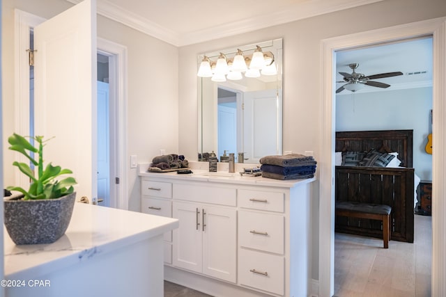 bathroom with ceiling fan, vanity, crown molding, and hardwood / wood-style floors