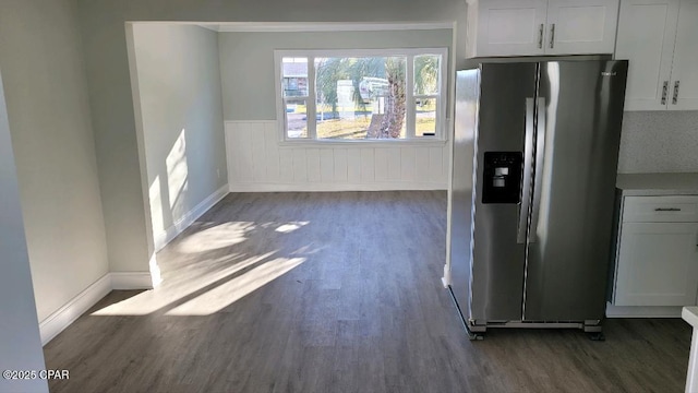 kitchen with stainless steel fridge with ice dispenser, dark wood-type flooring, and white cabinets