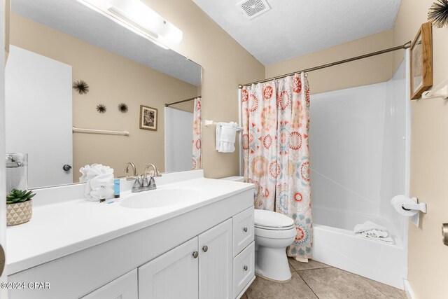 full bathroom with toilet, shower / tub combo, a textured ceiling, tile patterned flooring, and vanity