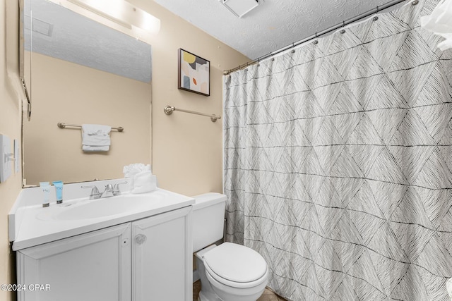 17670 Front Beach Rd Unit K5, Panama City Beach, FL 32413 - full bathroom with toilet, vanity, a textured ceiling, and curtained shower
