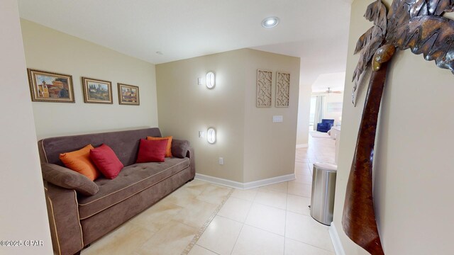 tiled living room with ceiling fan