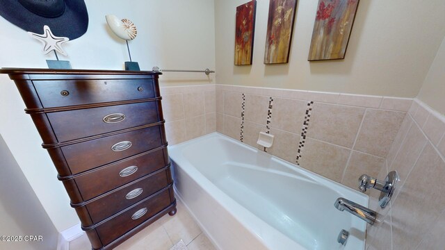 bathroom with a bathing tub and tile patterned flooring