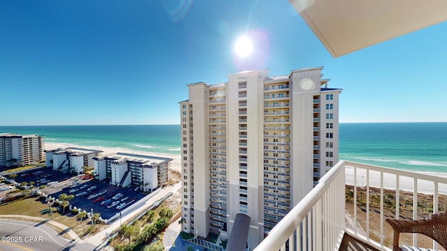 balcony featuring a beach view and a water view