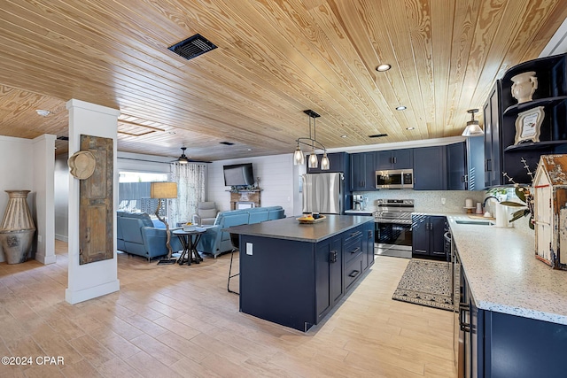 kitchen featuring stainless steel appliances, blue cabinets, ceiling fan, pendant lighting, and wooden ceiling