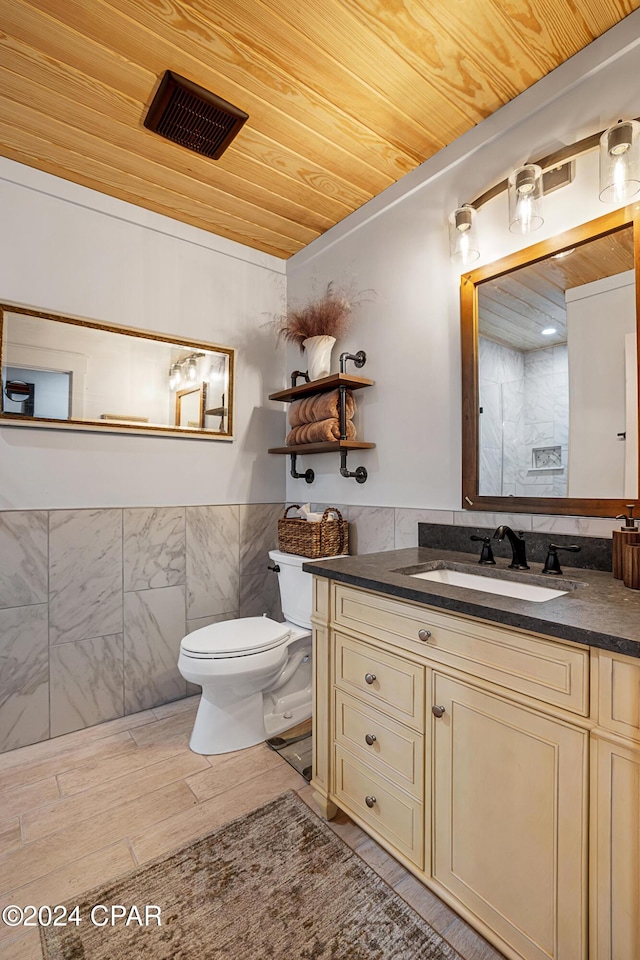 bathroom with vanity, toilet, tile walls, and wooden ceiling