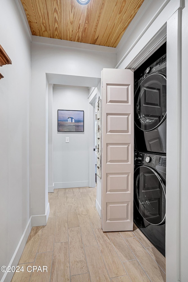 laundry room featuring stacked washer and dryer, wooden ceiling, and light hardwood / wood-style floors