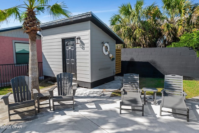 view of patio / terrace featuring a storage shed