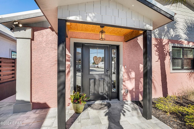 view of exterior entry with covered porch