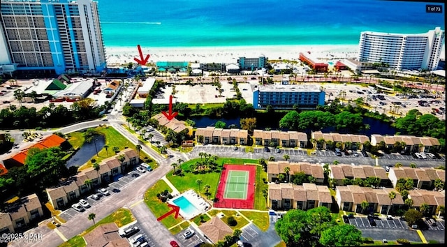 drone / aerial view featuring a beach view and a water view