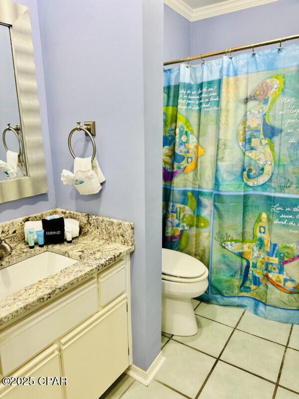 bathroom featuring ornamental molding, a shower with curtain, vanity, tile patterned flooring, and toilet