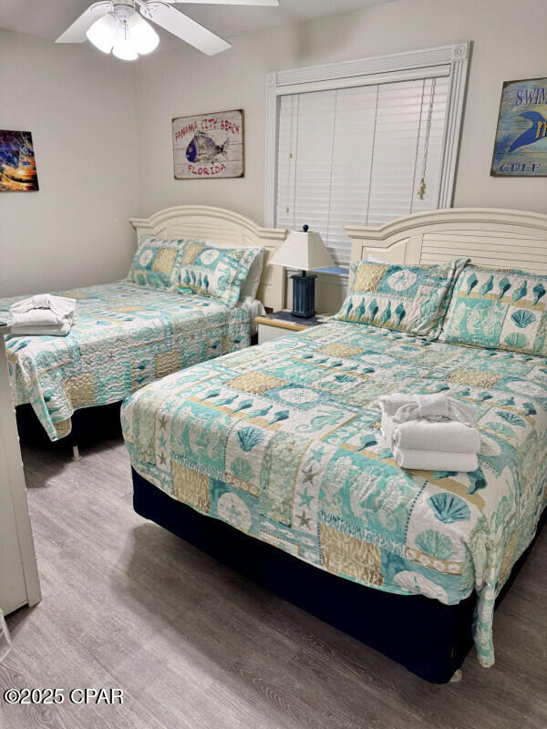 bedroom featuring ceiling fan and hardwood / wood-style flooring