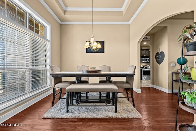 dining space with crown molding, plenty of natural light, dark hardwood / wood-style floors, and a notable chandelier