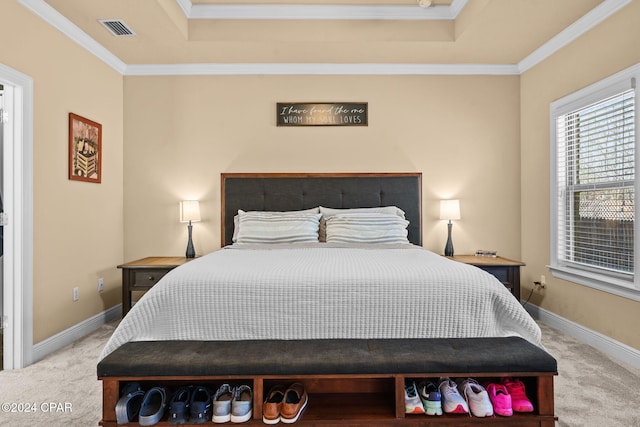 bedroom featuring a tray ceiling, crown molding, and light colored carpet