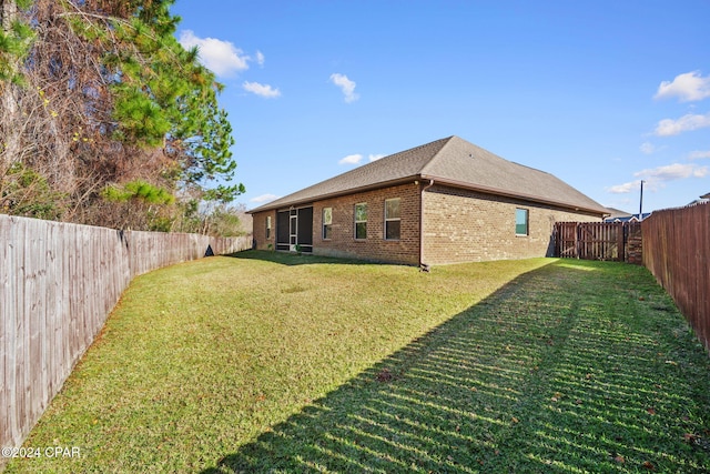 back of house featuring a lawn